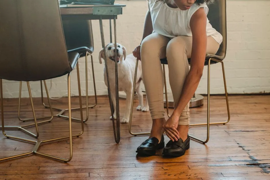 Dog owner and their Rottweiler sitting in a rental apartment together
