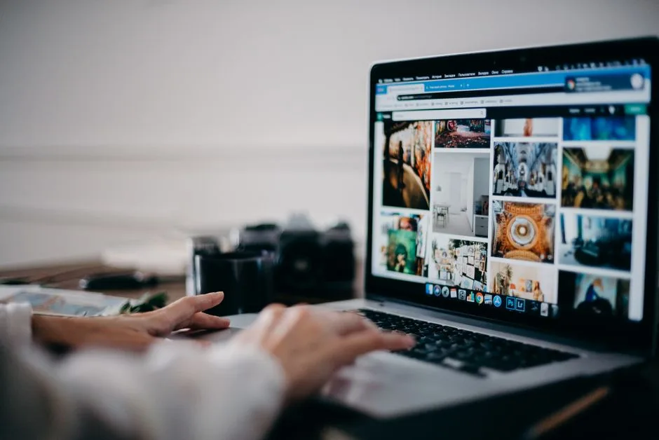 Person searching for pet-friendly apartments online while their dog sits beside them