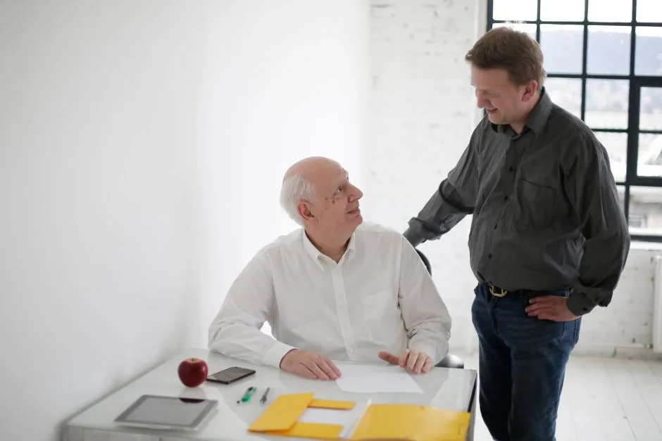 Tenant having a professional conversation with property manager at a desk